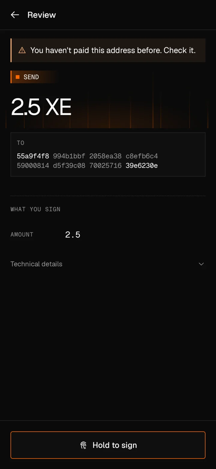 The review on Android before sending 2.5 XE: a warning that you haven't paid this address before, the full address, what you sign, technical details, and a Hold to sign button.