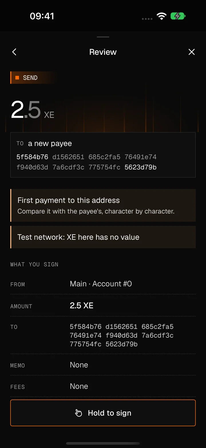 The review before sending 2.5 XE: the full address of a new payee, a warning that this is the first payment to the address, a note that XE on this test network has no value, what you sign line by line, and a Hold to sign button.